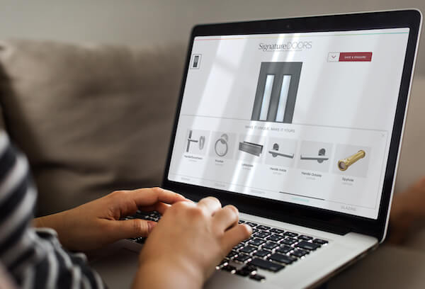 person on laptop using smarts door designer